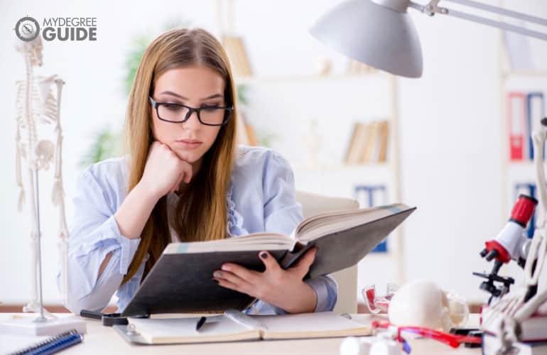 phd student studying a medical textbook