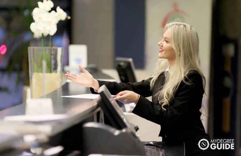 hotel manager welcomes guest in the reception area