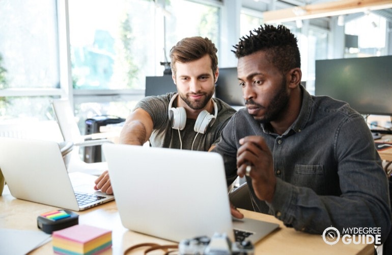 Computer programmers working together on a project