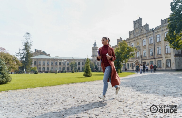 a student running across campus