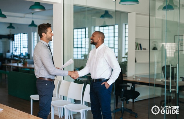 human resource manager shaking hands with a job applicant