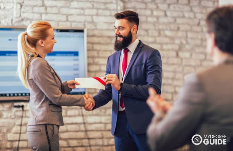 human resource professional receiving a certificate in an office