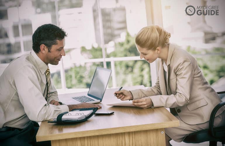 professional woman signing a contract of employment in an office