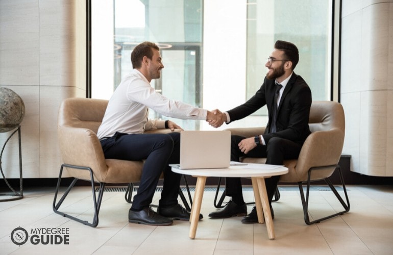 human resource manager talking to a colleague in an office