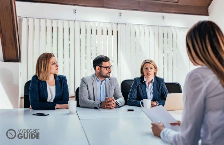 company's human resource persons interviewing a job applicant