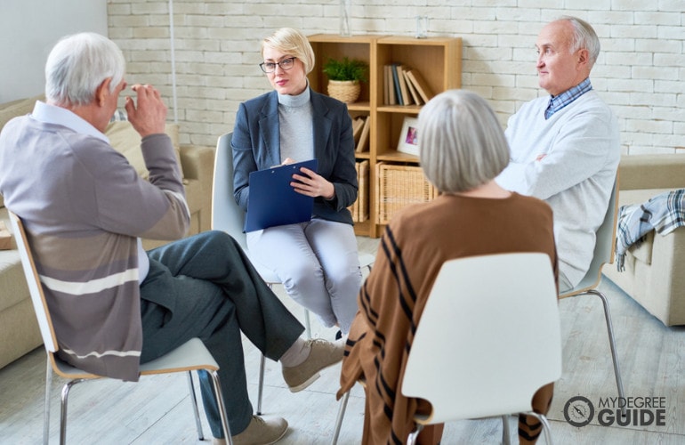 female therapist talking to her patients in a group home