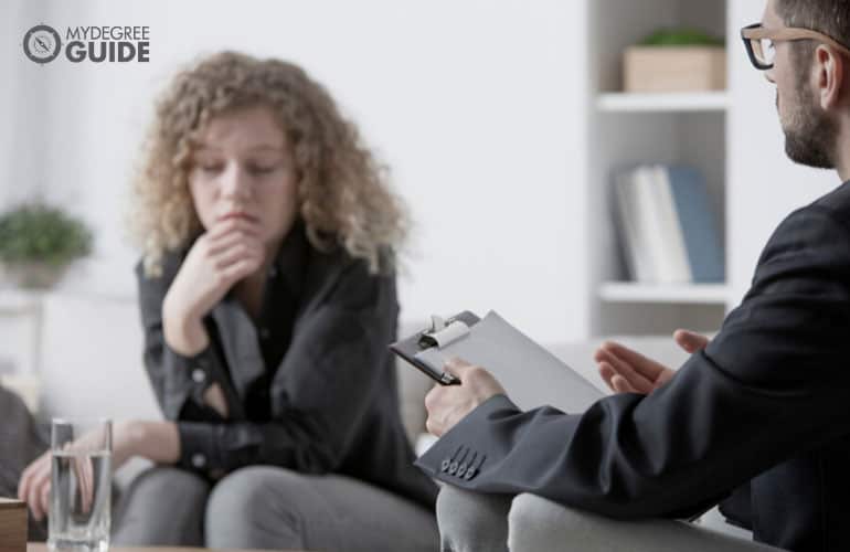 psychologist talking to a patient in his office