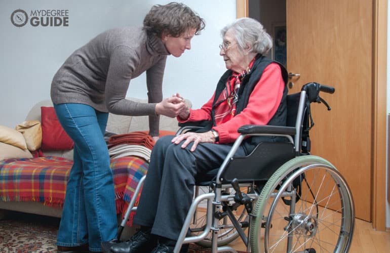 caregiver taking care of a senior woman on a wheelchair