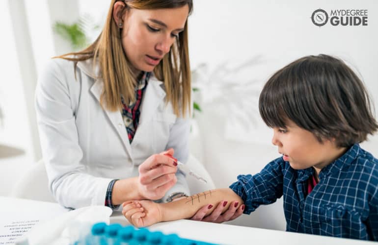 immunologist checking a young patient