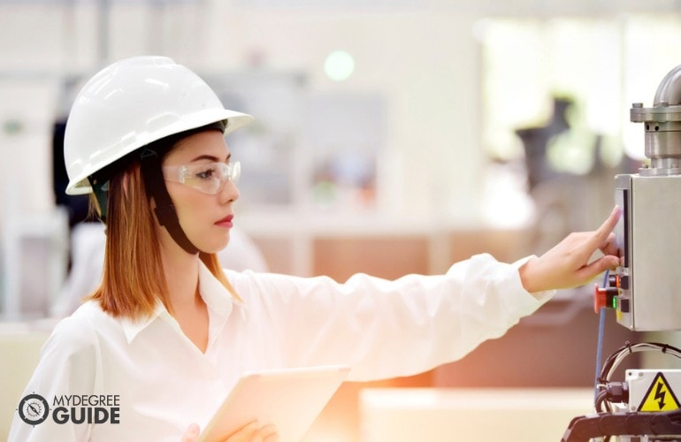 Industrial Engineering Degree checking the equipment in a factory