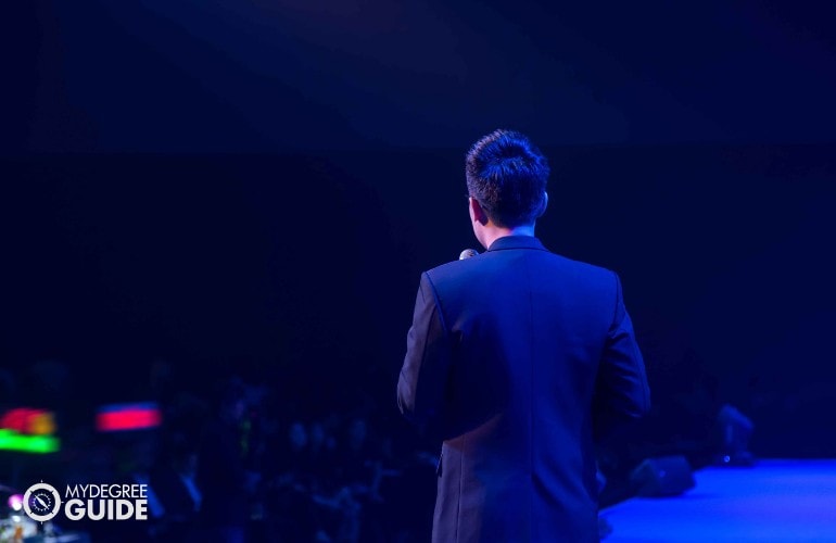 male speaker talking to international audience