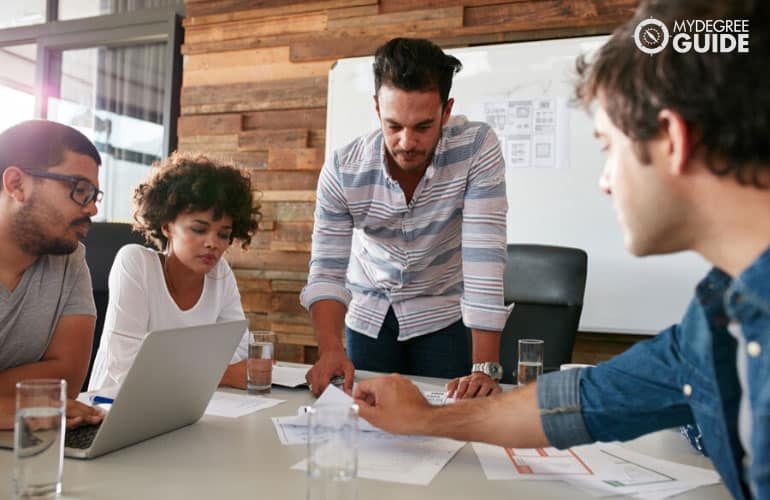 marketing director discussing with his team during a meeting