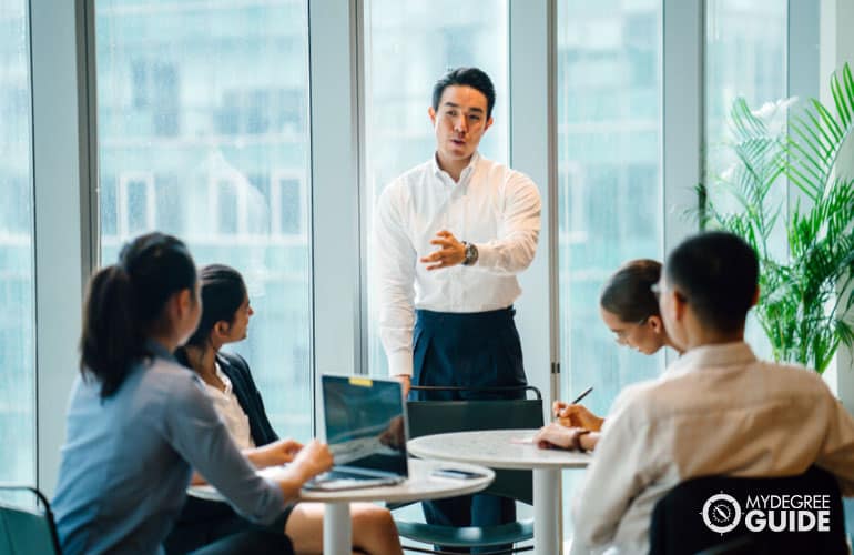 marketing director having a meeting with his team