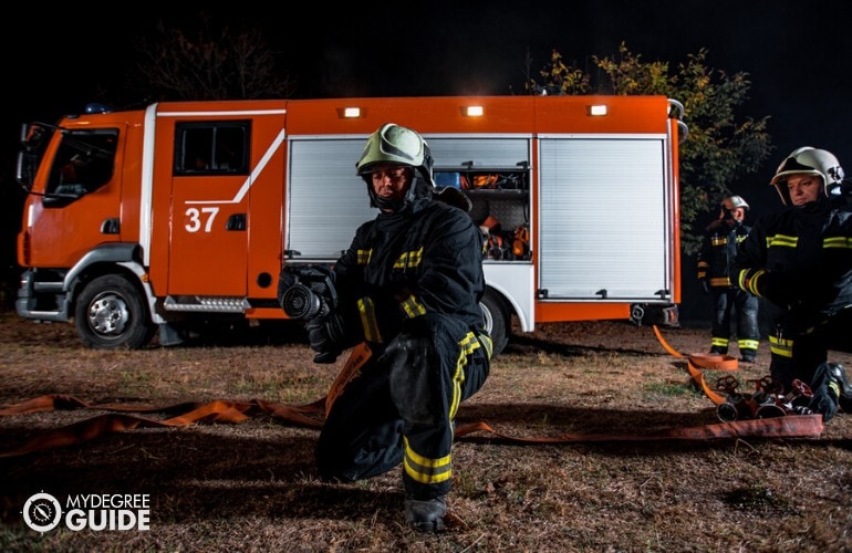 firefighters working together to put out a fire