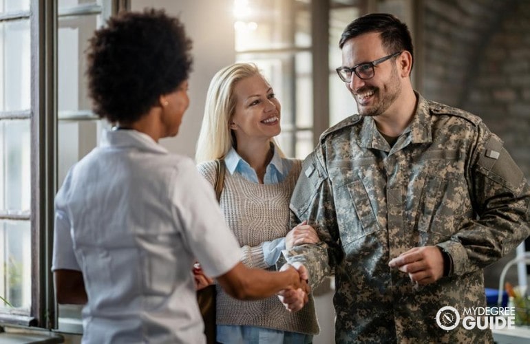 Military personnel visiting his Alma mater with his wife