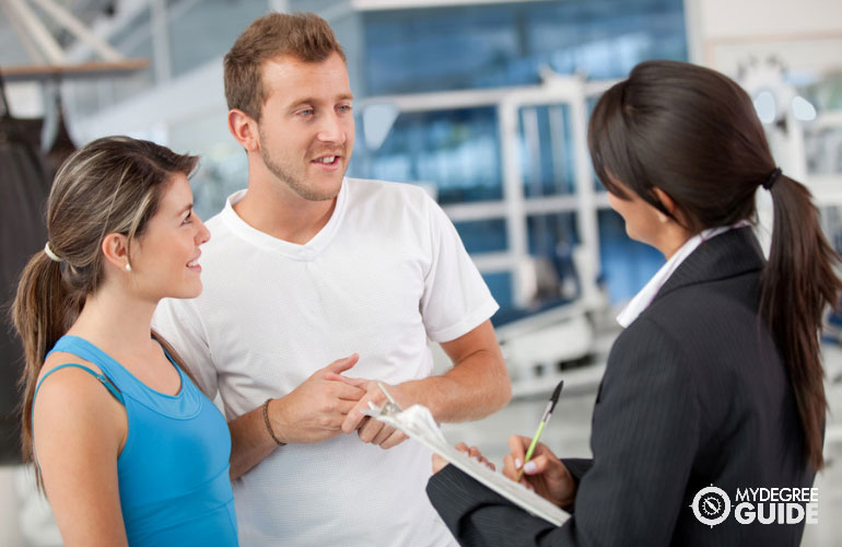 sports manager talking to athletes in a gym