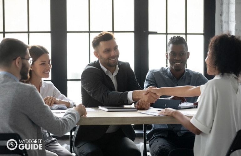 human resource managers congratulating an employee