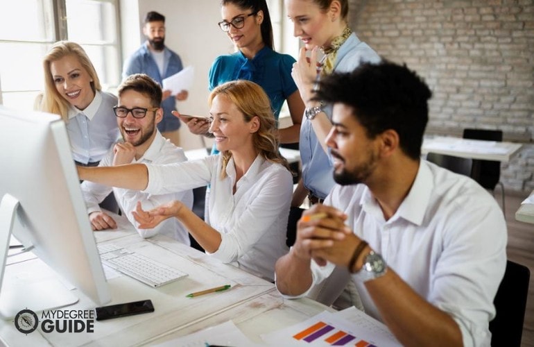 marketing manager looking at her team's work on the computer