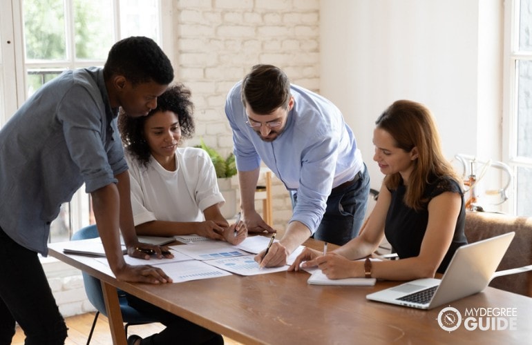 Statisticians working together in a conference room