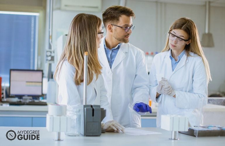 Geoscientists discussing in the lab