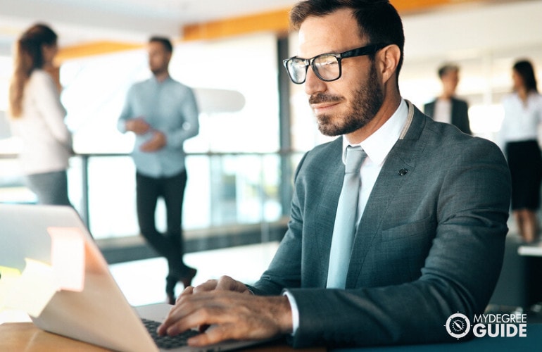 male manager working on his laptop