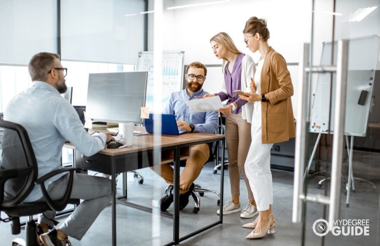 professionals consulting their work to a colleague