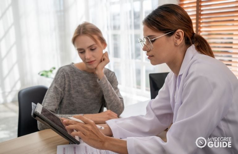 Mental Health Counselor reviewing a patient's progress chart