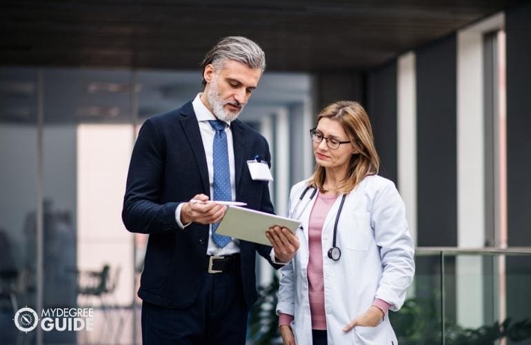 Medical & Health Services Manager discussing with a doctor