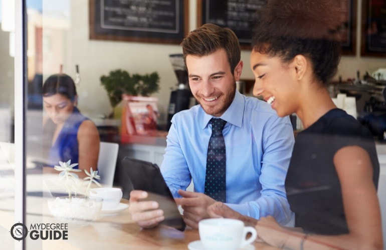 business professionals happily working at a cafe