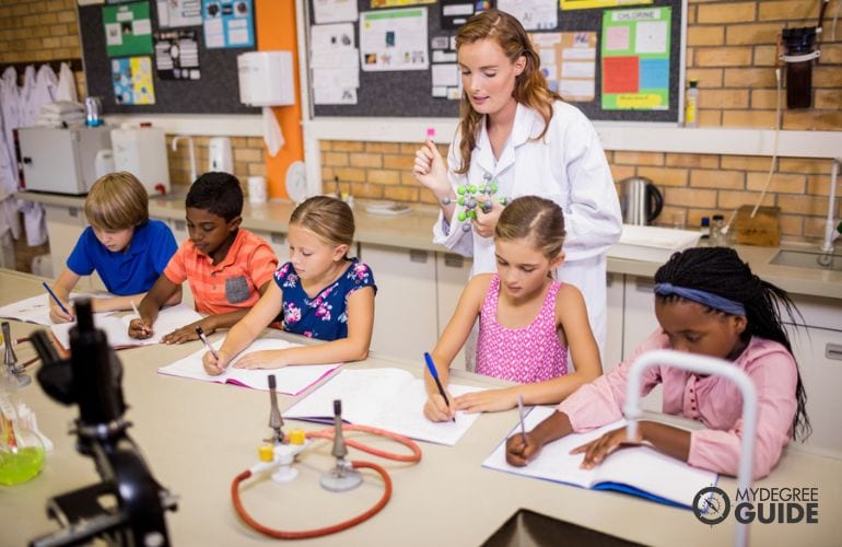 Teacher and elementary students during science class