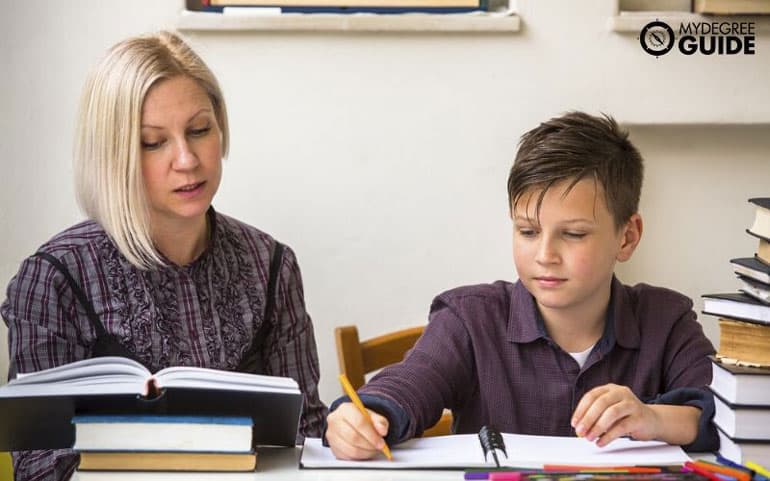 K-12 teaching young boy in classroom