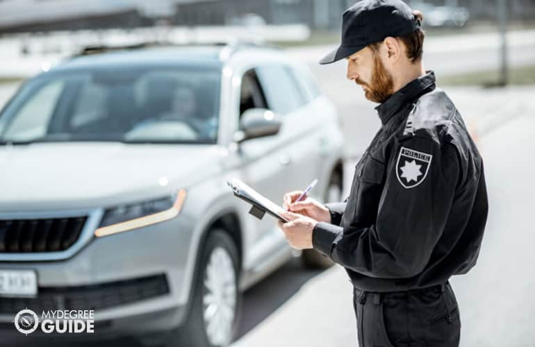 police traffic officer checking the speed of cars