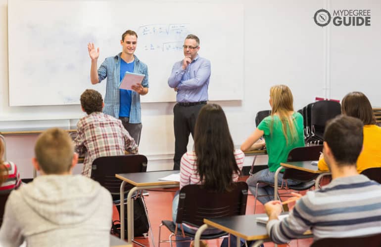 male college student reporting in front of class