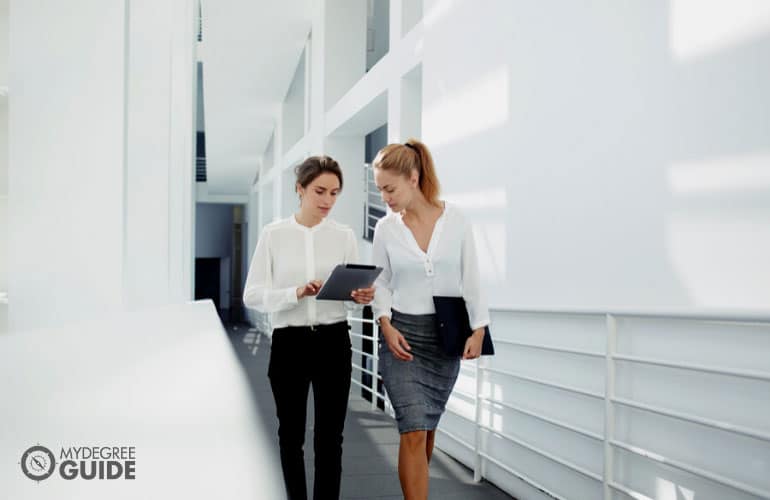 female colleagues talking on the hallway