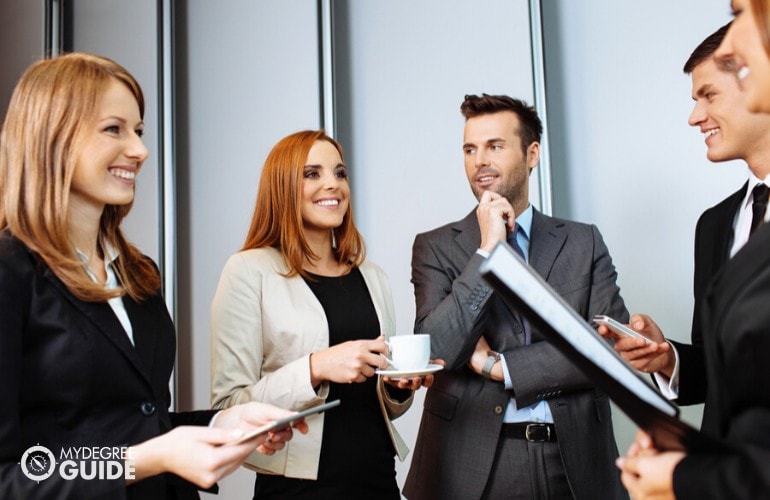 business professionals having a conversation during a seminar