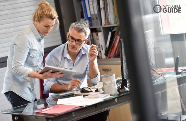 management consultant mentoring an employee in his office