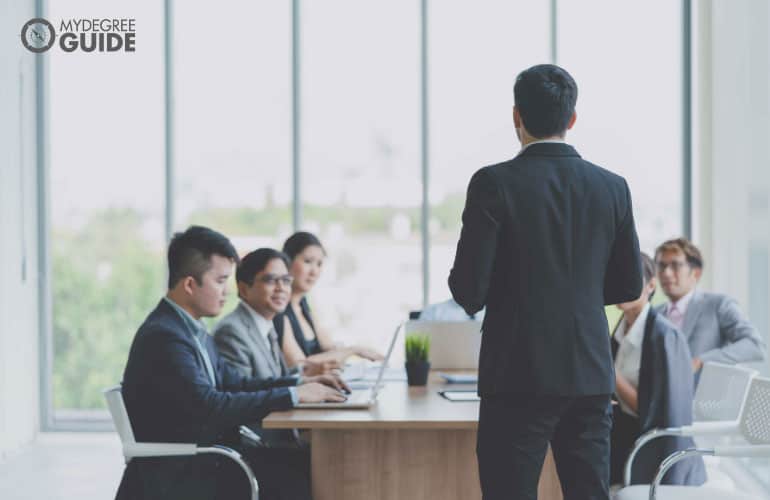 male employee talking to his team during a meeting