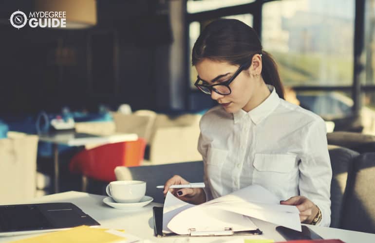 administrative assistant working on some documents in a cafe