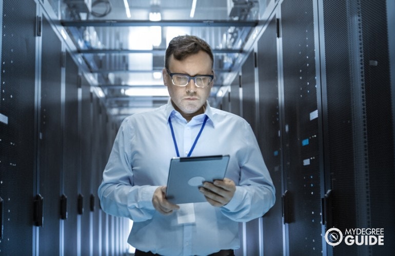 Management Information Systems Manager checking the data room