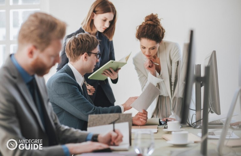 Marketing Managers checking presentation in office