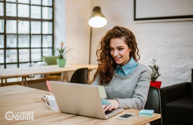 social media marketing specialist working on her laptop