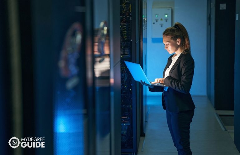 woman with laptop checking mainframe