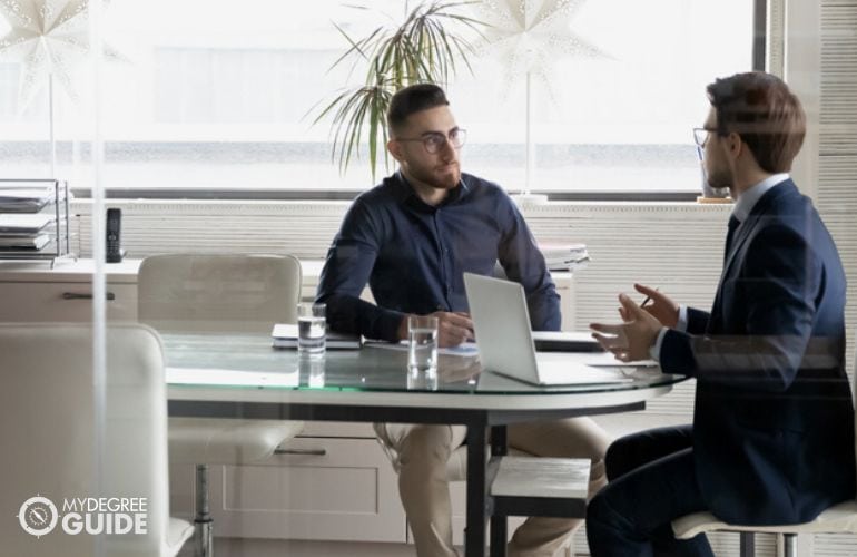 Human Resources Specialist discussing with an intern