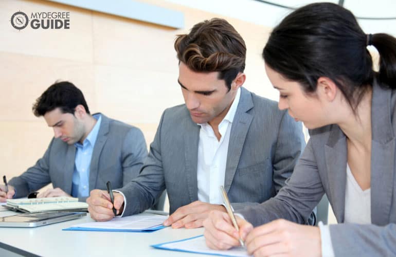 master's degree graduates filling out job application forms