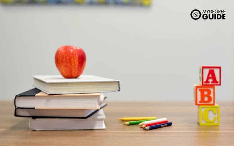 apple and books on table