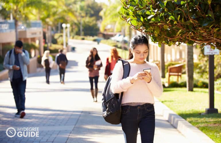 student walking across campus