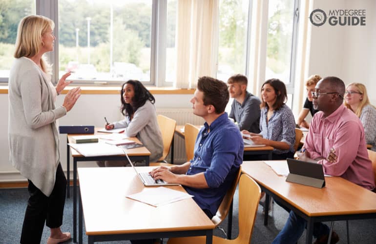 a professional teaching a group of adult learners