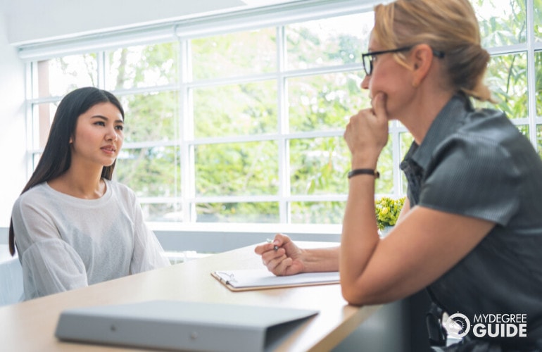 student applying for a Masters in Applied Behavior Analysis listening to interviewer during admissions interview