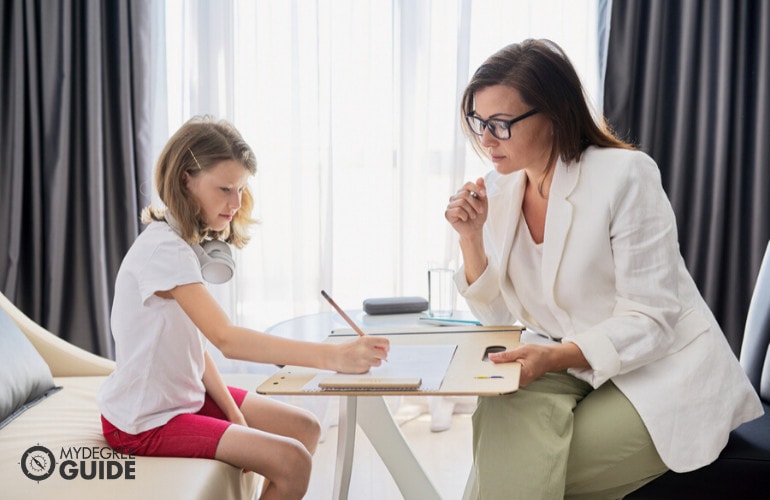 Psychologist with a child during therapy