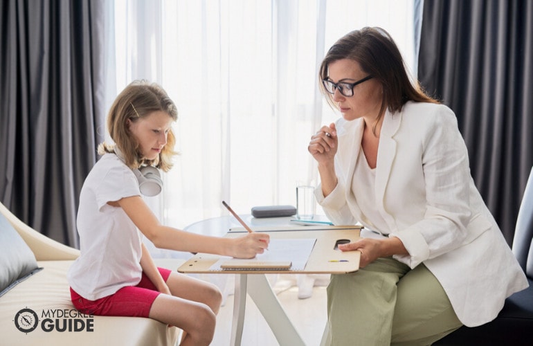 Psychologist with a child during therapy